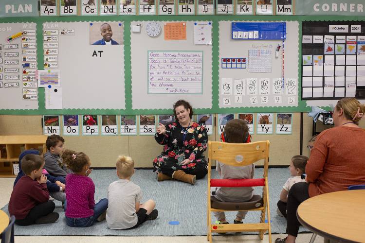 Michaela Eckler, center, greets her kindergarten students during morning meeting time in their classroom at Dothan Brook School in White River Junction, Vt., on Tuesday, Oct. 8, 2024. Eckler’s students returned to their homeroom on Friday after spending just over a month in a makeshift classroom set up in the school’s gymnasium while mold remediation was conducted in several first floor classrooms and office spaces. (Valley News - Alex Driehaus)
